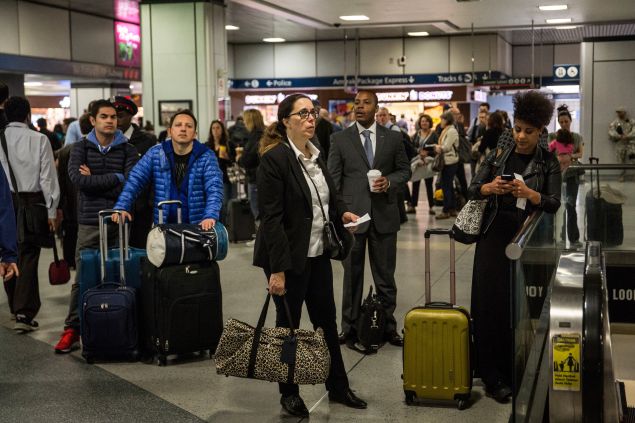 Travellers wait for train information in the Amtrak terminal of New York Penn Station on May 14, 2015 in New York City.   