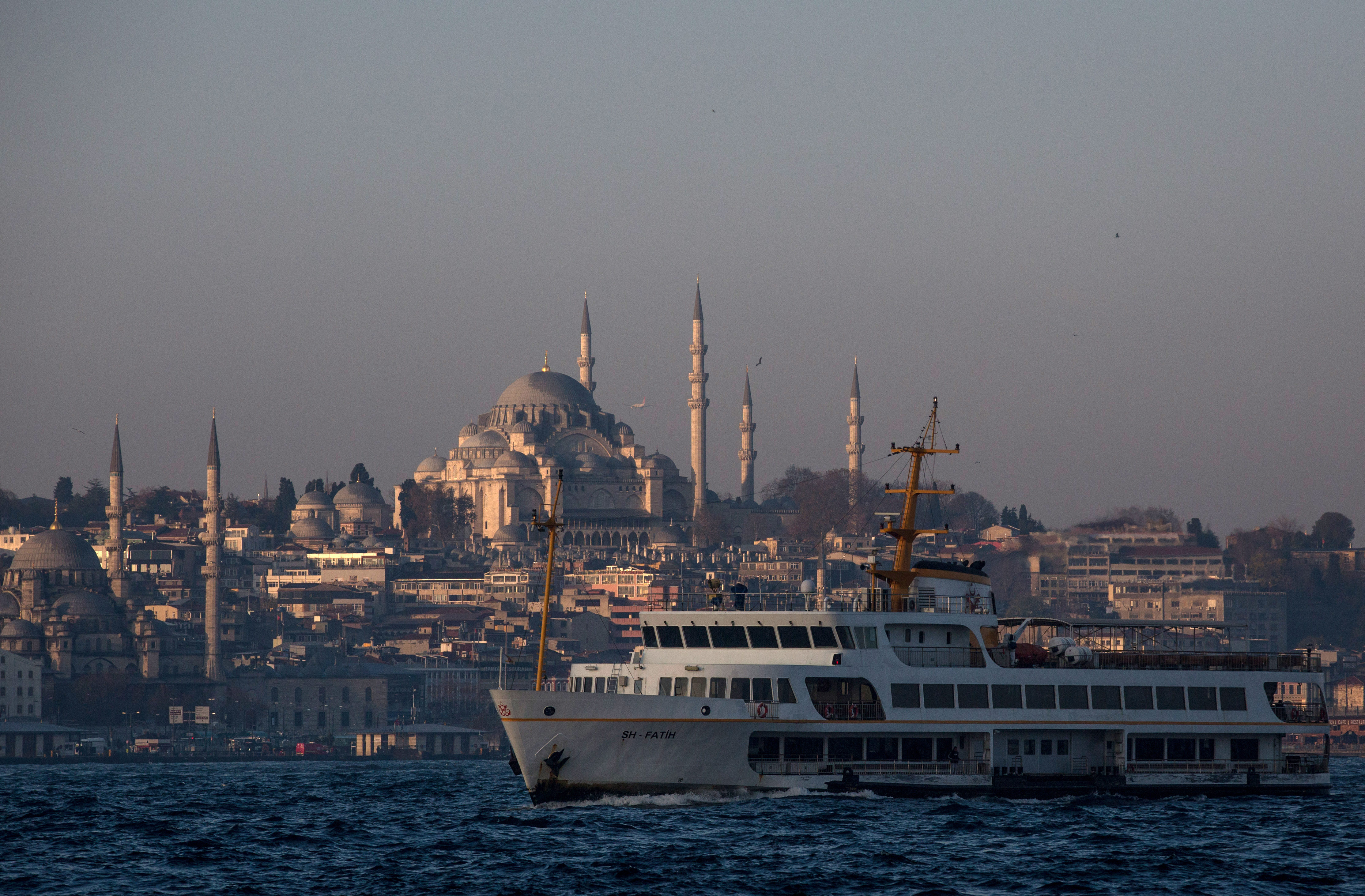 ISTANBUL, TURKEY - DECEMBER 14: A ferry is seen on route to the Asian side on December 14, 2015 in Istanbul, Turkey. Istanbul in Turkey's northwest is the only city on earth spanning two continents. The Bosphorus, a small stretch of water divides Europe from Asia. Istanbul's world famous ferries are one of the most popular ways to get around the city, it is estimated that more than 300,000 people take the ferry to work each day.