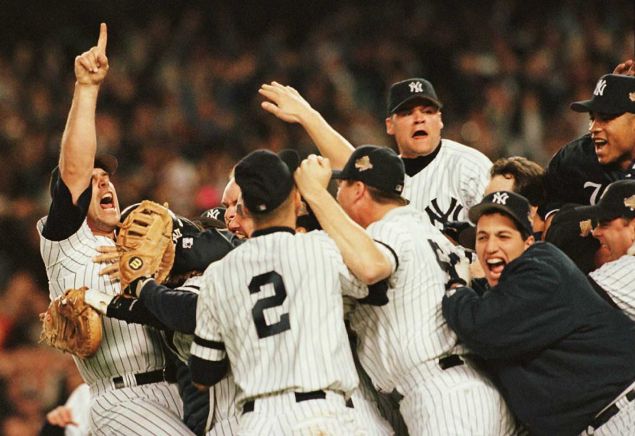 Members of the New York Yankees celebrate on the pitchers mound after beating the Atlanta Braves to win the World Series at Yankee Stadium in New York 26 October.