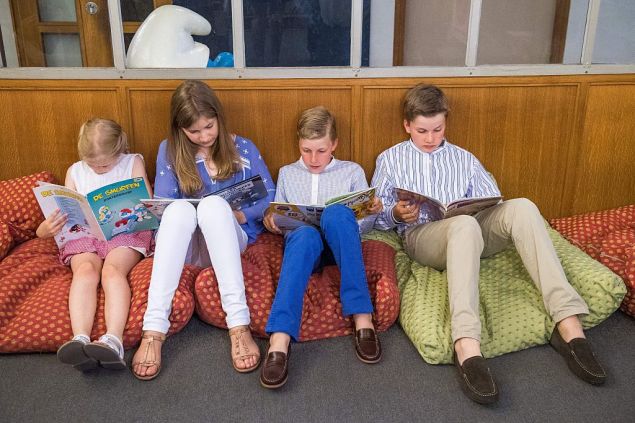 (From L) Princess Eleonore, Crown Princess Elisabeth, Prince Emmanuel and Prince Gabriel read a comic book during a photo-shoot of the Belgian Royal Family's vacation Belgian Comic Strip Center, in Brussels, on July 19, 2016. / AFP / Belga / LAURIE DIEFFEMBACQ / Belgium OUT (Photo credit should read LAURIE DIEFFEMBACQ/AFP/Getty Images)