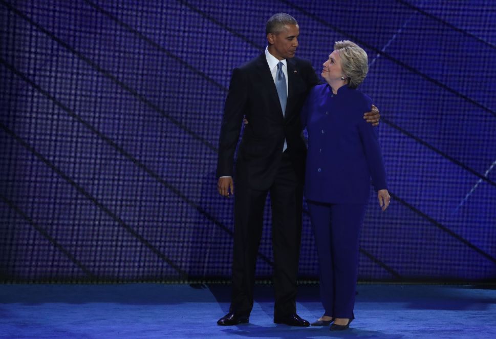 US President Barack Obama and Democratic Presidential nominee Hillary Clinton embrace on the third day of the Democratic National Convention at the Wells Fargo Center, July 27, 2016 in Philadelphia, Penn.