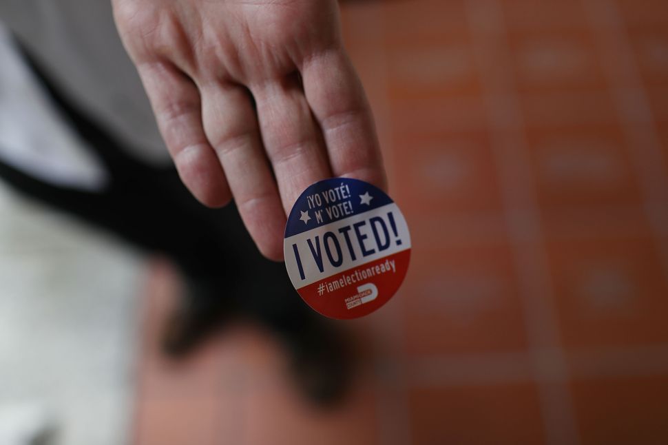 A voter shows off his, 'I Voted!', sticker after voting in the Florida primary on August 30, 2016 in Miami, Florida. There are Senate seats as well as congressional races that voters are weighing in on