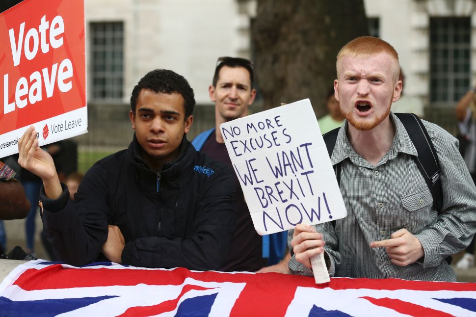 A man carrying an anti-EU pro-Brexit placard shouts in a counter protest against pro-Europe marchers on a March for Europe demonstration against the Brexit vote in Parliament Square in central London on September 3, 2016
