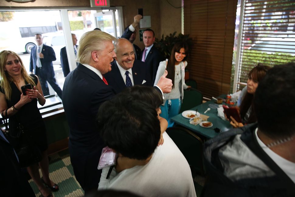MIAMI, FL - SEPTEMBER 27: Republican presidential nominee Donald Trump and advisor, former New York City Mayor Rudy Giuliani, stop by a coffee shop in a Hispanic neighborhood after Trump spoke at a town hall meeting with members of the Hispanic community the morning after his first debate with Democratic presidential nominee Hillary Clinton on September 27, 2016 at Miami Dade College in Miami, Florida.
