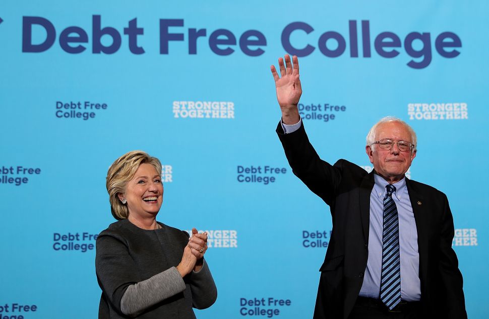Democratic presidential nominee former Secretary of State Hillary Clinton (L) and U.S. Sen. Bernie Sanders (I-VT) greet supporters during a campaign rally at University of New Hampshire on September 28, 2016 in Durham, New Hampshire. Hillary Clinton is campaigning in New Hampshire.