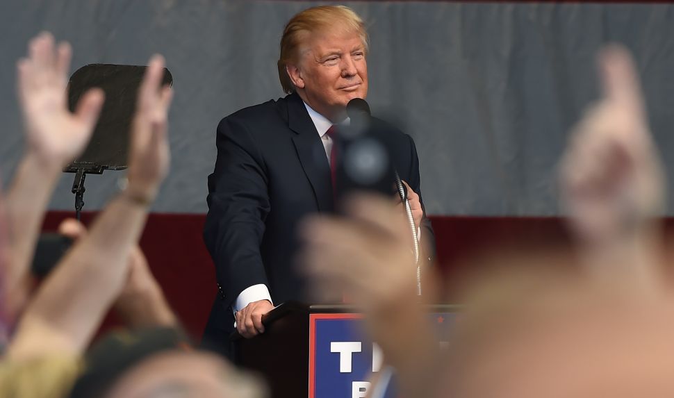 Supporters listen to Republican presidential candidate Donald Trump at a campaign rally at the Henderson Pavilion, October 5, 2016 in Henderson, Nevada. / AFP /
