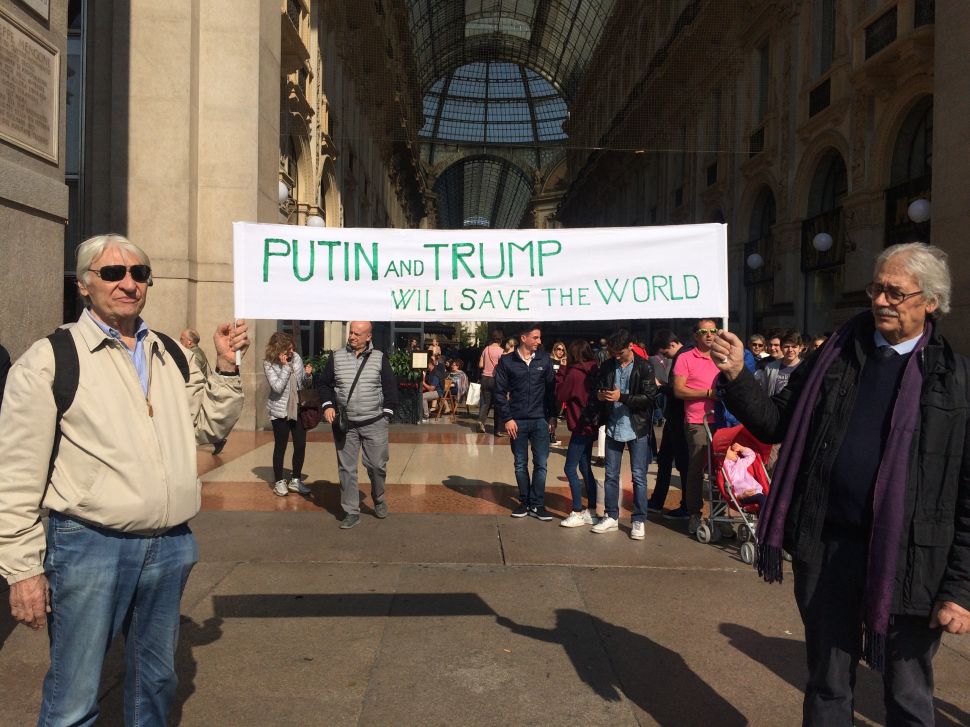 Vladimir Putin and Donald Trump supporters are seen on October 7, 2016 in Milan, Italy.