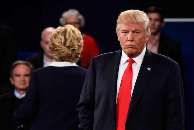 ST LOUIS, MO - OCTOBER 09: Democratic presidential nominee former Secretary of State Hillary Clinton (L) and Republican presidential nominee Donald Trump listen to a question during the town hall debate at Washington University on October 9, 2016 in St Louis, Missouri. This is the second of three presidential debates scheduled prior to the November 8th election. (Photo by Saul Loeb-Pool/Getty Images)