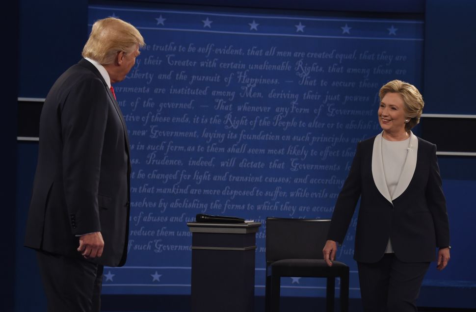 Republican nominee Donald Trump and Democratic nominee Hillary Clinton arrive on the stage before they participate in the 2nd debate at Washington University in St. Louis