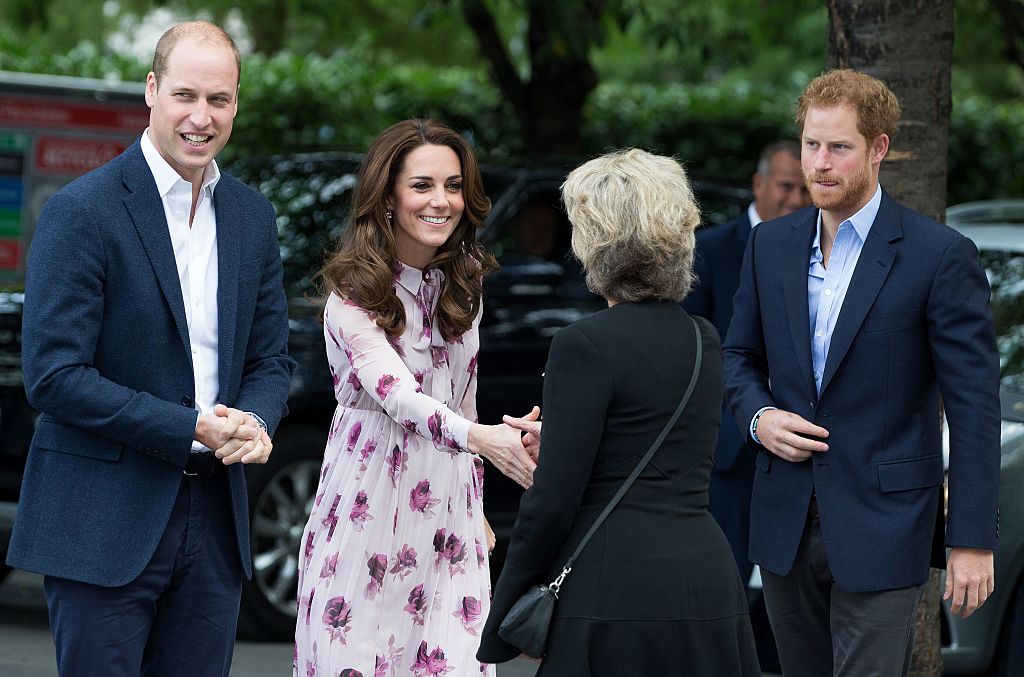 Prince William, Catherine, Duchess of Cambridge (2L) and Britain's Prince Harry (R) are greeted as they arrive for a visit to County Hall and The London Eye in central London on October 10, 2016. The Duke and Duchess of Cambridge, along with Prince Harry, were due to speak at an event recognising World Mental Health day.