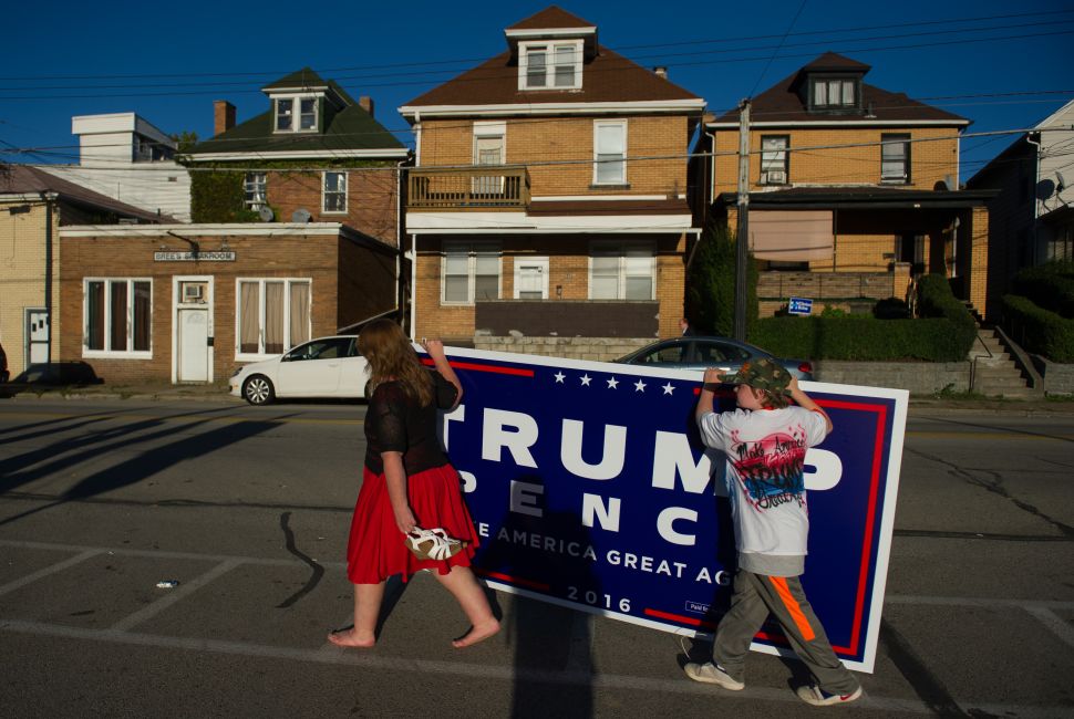 Two supporters of Republican candidate for President Donald J Trump leave after a rally where the candidate some to a crowd of 3000 at Ambridge Area Senior High School on October 10, 2016 in Ambridge, Pennsylvania. Ambridge, Pennsylvania, named after the American Bridge Company, a steel fabricating plant that employed 60,000 workers is a traditionally Democratic stronghold, but is shifting Republican as a shrinking tax base and lost jobs having devastating economic effects on the former industrial community. 