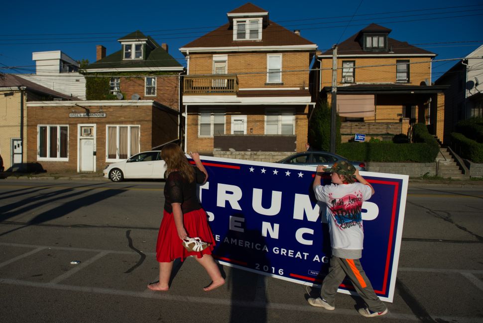 Two supporters of Republican candidate for President Donald J Trump leave after a rally where the candidate some to a crowd of 3000 at Ambridge Area Senior High School on October 10, 2016 in Ambridge, Pennsylvania. Ambridge, Pennsylvania, named after the American Bridge Company, a steel fabricating plant that employed 60,000 workers is a traditionally Democratic stronghold, but is shifting Republican as a shrinking tax base and lost jobs having devastating economic effects on the former industrial community.