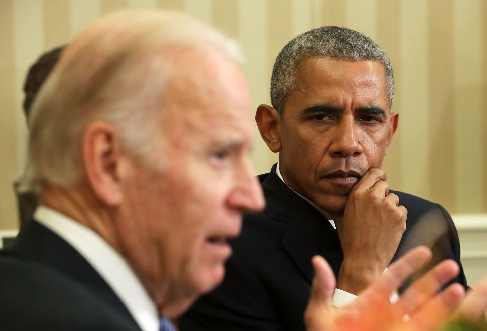 WASHINGTON, DC - OCTOBER 17: U.S. Vice President Joseph Biden (L) speaks as President Barack Obama (R) listens during a meeting to release the Cancer Moonshot Report in the Oval Office of the White House October 17, 2016 in Washington, DC. Vice President Biden released the report, which focused on speeding up the development of battling the deadly disease.