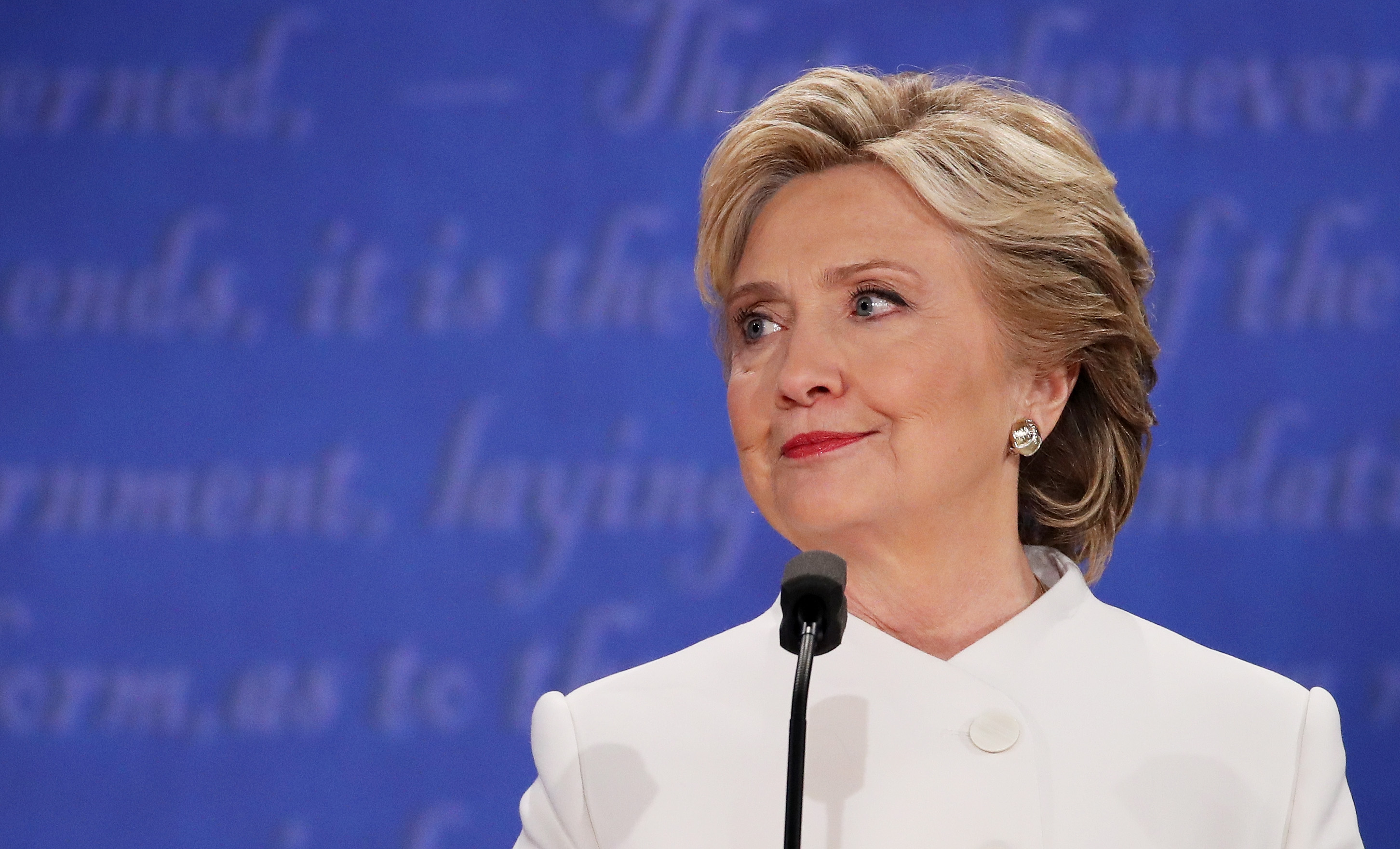 Hillary Clinton listens to Republican presidential nominee Donald Trump speak during the third U.S. presidential debate at the Thomas & Mack Center on October 19, 2016 in Las Vegas, Nevada.