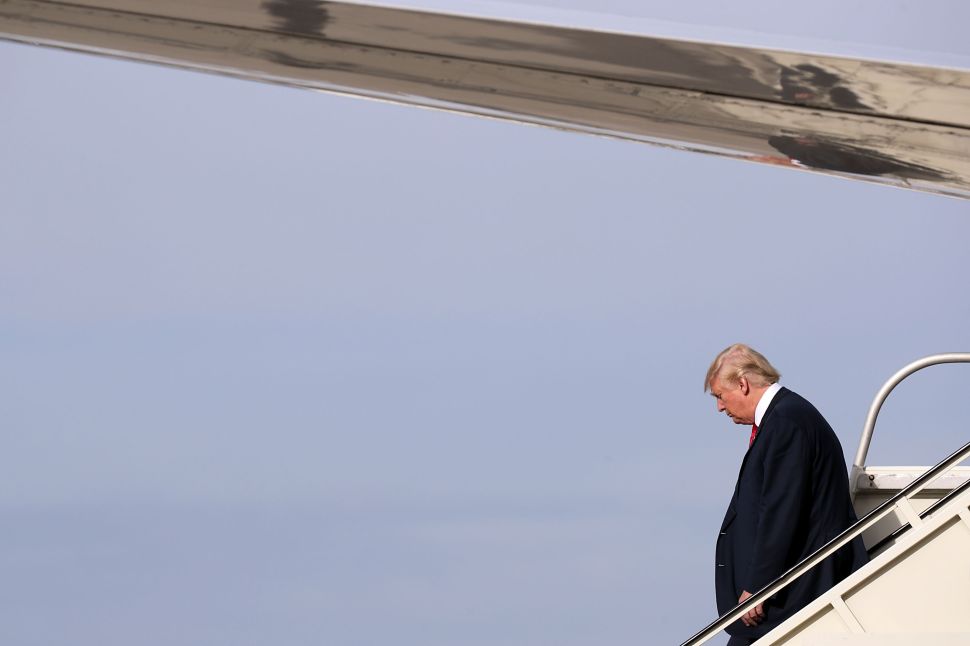ROMULUS, MI - OCTOBER 31: Republican presidential nominee Donald Trump steps off of his airplane at Detroit Metropolitan Wayne County Airport before heading to a campaign rally in Warren October 31, 2016 in Romulus, Michigan. With just eight days until the election, polls show a slight tightening in the race.