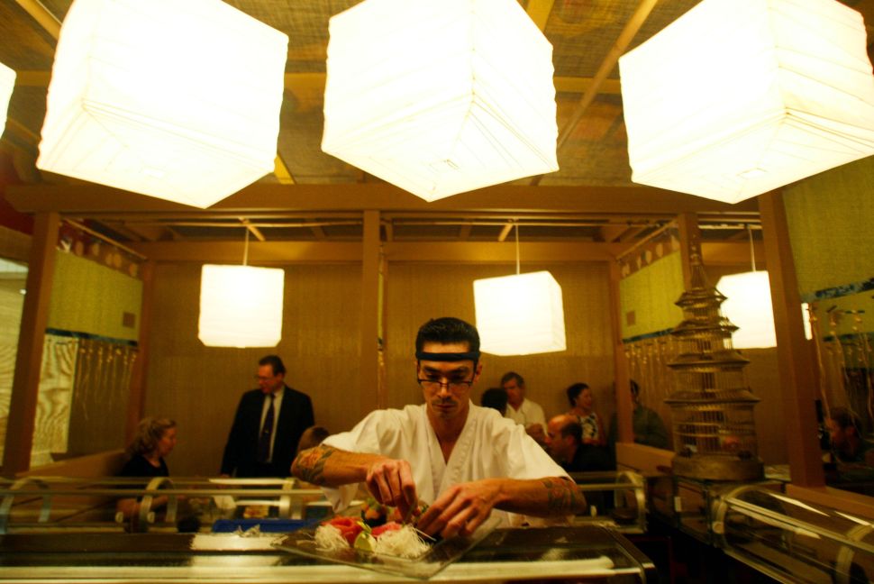 400034 01: Sushi chef Joe Bracero prepares a plate January 23, 2002 at the debut of the Sushi Doraku restaurant in South Beach, Florida. The new sushi concept restaurant created by the Benihana corp. offers customers sushi, sake and music.