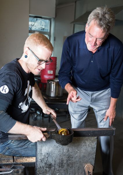 Beers watches over the creation of a hand-blown lamp.