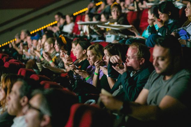 Guests taste culinary creations as they watch them on screen at opening night of the 10th Annual Food Film Festival.