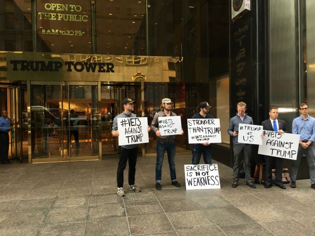 A group of local U.S. military veterans rally in front of Trump Tower.