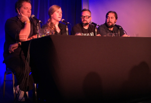 Criminals Phoebe Judge, speaking, at the LA Podfest. On stage with Jay Larson, Hal Lublin and Jeffrey Cranor.