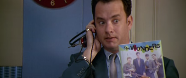 Tom Hanks using a prehistoric iPhone to listen a floppy disk (I presume).
