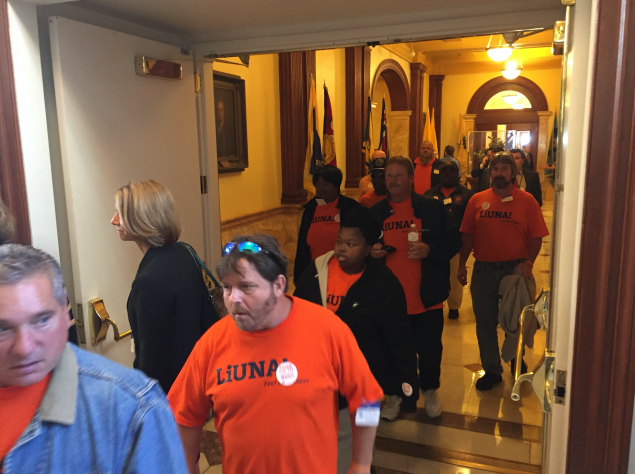Laborers file out of Senate Chambers in Trenton after a vote to put them back to work by funding the Transportation Trust Fund is delayed.