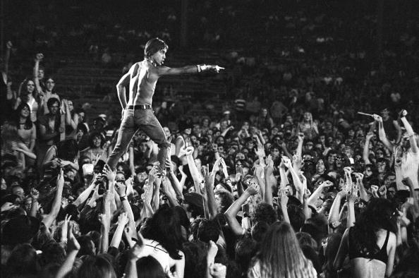 Iggy Pop of the Stooges rides the crowd during a concert at Crosley Field on June 23, 1970 in Cincinnati, Ohio.