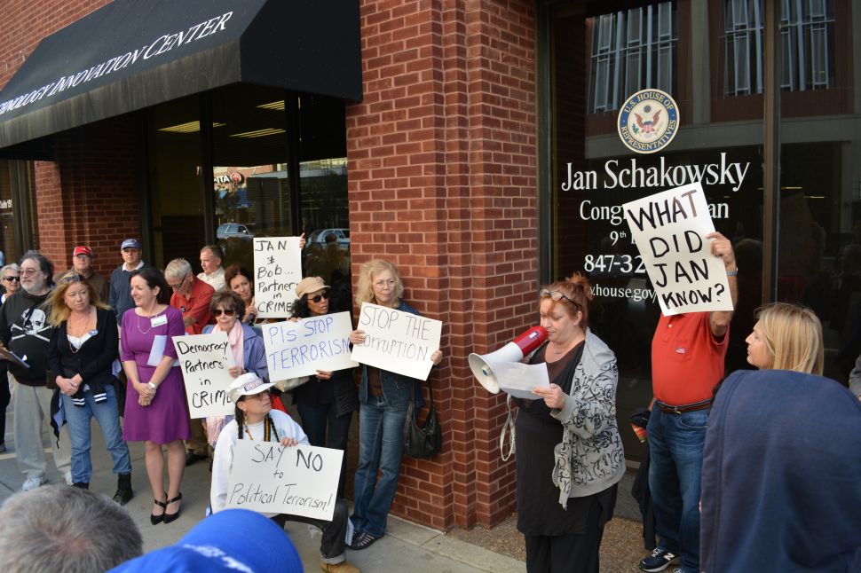 District resident Suzzanne Monk leading a protest outside of the Congressional Office of Jan Schakowsky. Monk is calling for investigations into Schakowsky and her husband political consultant Robert Creamer for potential incitement of violence at political rallies