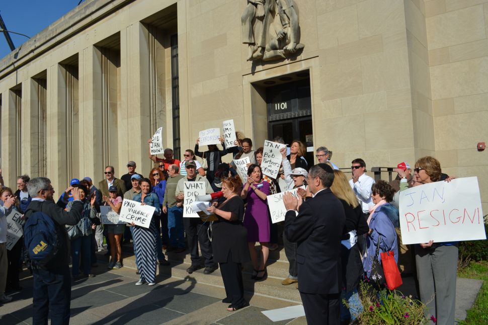 Political activist Suzzanne Monk reading letters calling for investigations by the FBI, FEC, and Illinois Attorney General against Rep. Jan Schakowsky and her husband political consultant Robert Creamer. Monk and fellow protesters delivered the letters to the Evanston post office after holding rally in front of Schakowsky’s Congressional Office.