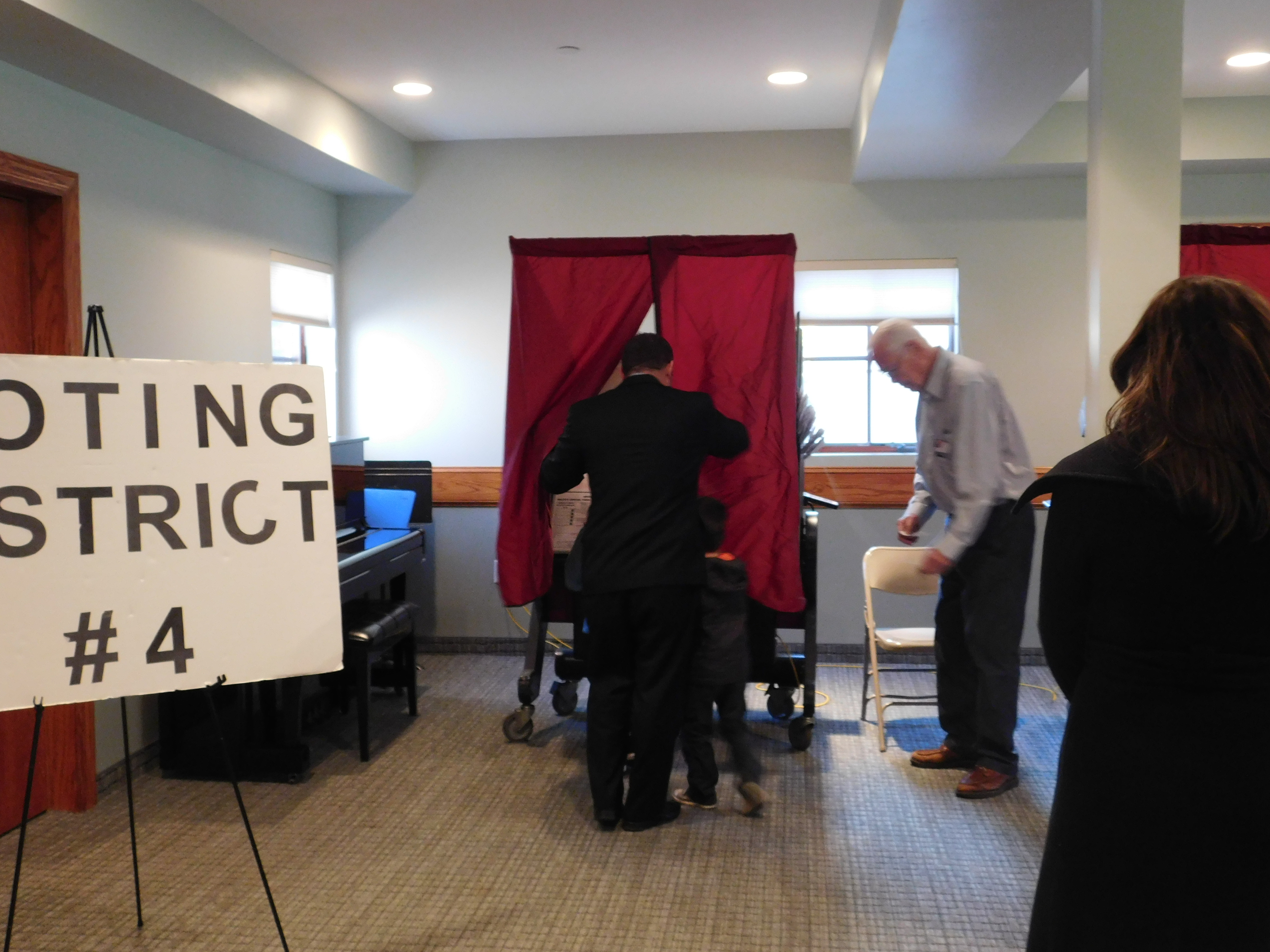 Gottheimer enters the voting booth with his children Ben and Ellie.