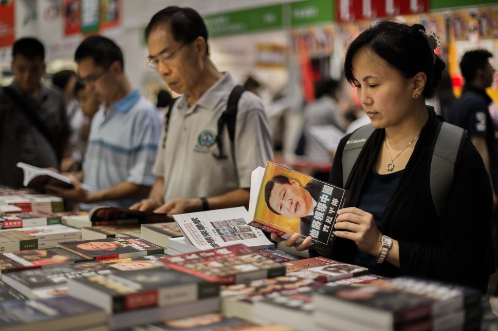 Visitors browse Chinese political books at the Hong Kong Book Fair in Hong Kong on July 18, 2012.