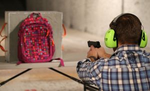 SALT LAKE CITY, UT - DECEMBER 21: Chief Operating Officer for Amendment II, Rich Brand, shoots a child's backpack with their Rynohide CNT Shield in it on December 21, 2012 in Salt Lake City, Utah. Their orders for the bulletproof shield have gone up dramatically since the school shooting in Connecticut last week. (Photo by George Frey/Getty Images)