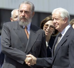 Cuban President Fidel Castro (L) greets former US president Jimmy Carter (R) after Carter's speech in Havana 12 May 2002.