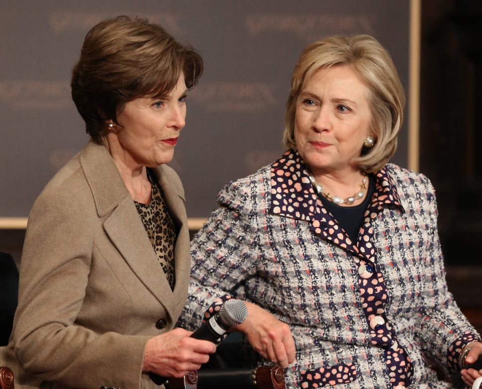 Former Secretary of State Hillary Clinton (R) and former first lady Laura Bush participate in an event to advance the women of Afghanistan in 2013.