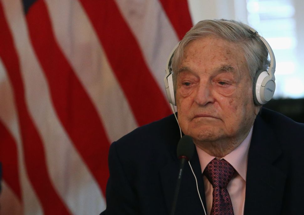 Billionaire George Soros listens to remarks by Commerce Secretary Penny Pritzker and Tunisian President Beji Caid Essebsi during a roundtable discussion with a group of American business leaders, at the Blair House May 20, 2015 in Washington, DC.