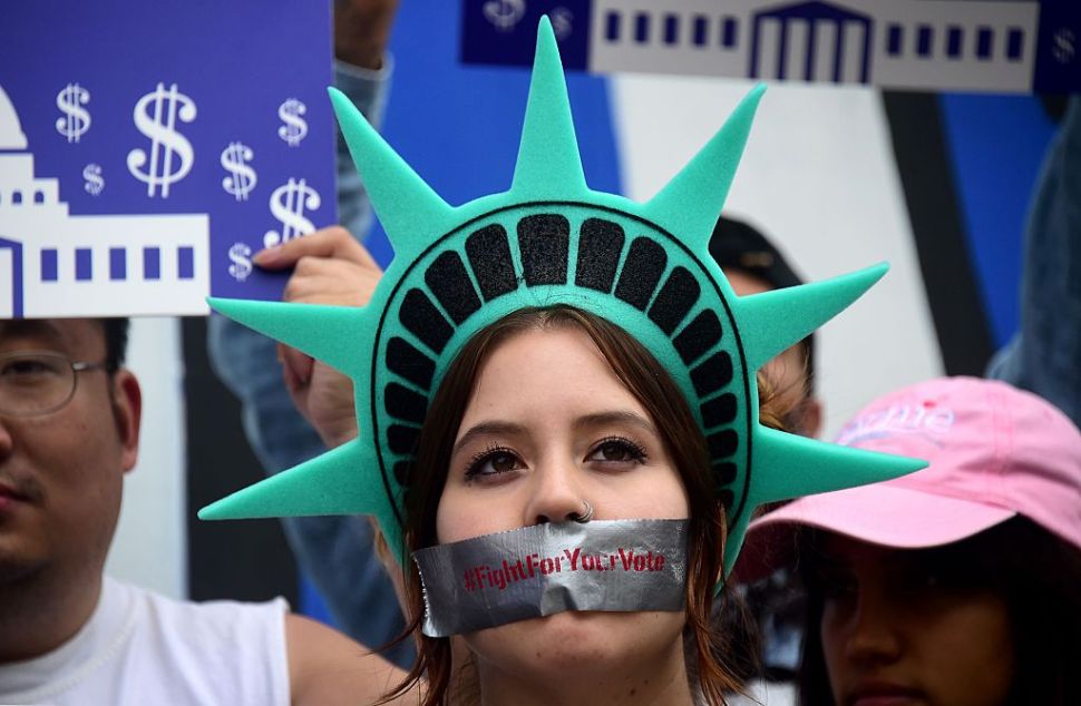 Protesters listen as actress Frances Fisher speak in support of Bernie Sanders backed by his supporters during a downtown rally in Los Angeles, California on May 19, 2016, to bring attention to voter suppression in Nevada. / AFP / FREDERIC J. BROWN (Photo credit should read FREDERIC J. BROWN/AFP/Getty Images)
