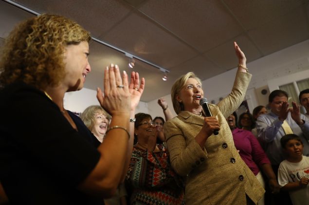Rep. Debbie Wasserman Schultz looks on as Democratic presidential nominee Hillary Clinton speaks as she stops by her campaign headquarters on August 9, 2016 in Davie, Florida.