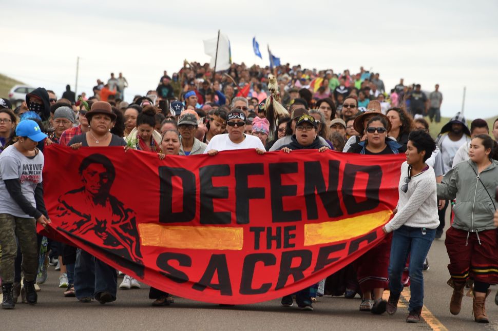 Native Americans march to the site of a sacred burial ground that was disturbed by bulldozers building the Dakota Access Pipeline (DAPL), near the encampment where hundreds of people have gathered to join the Standing Rock Sioux Tribe's protest of the oil pipeline slated to cross the nearby Missouri River, September 4, 2016 near Cannon Ball, North Dakota.