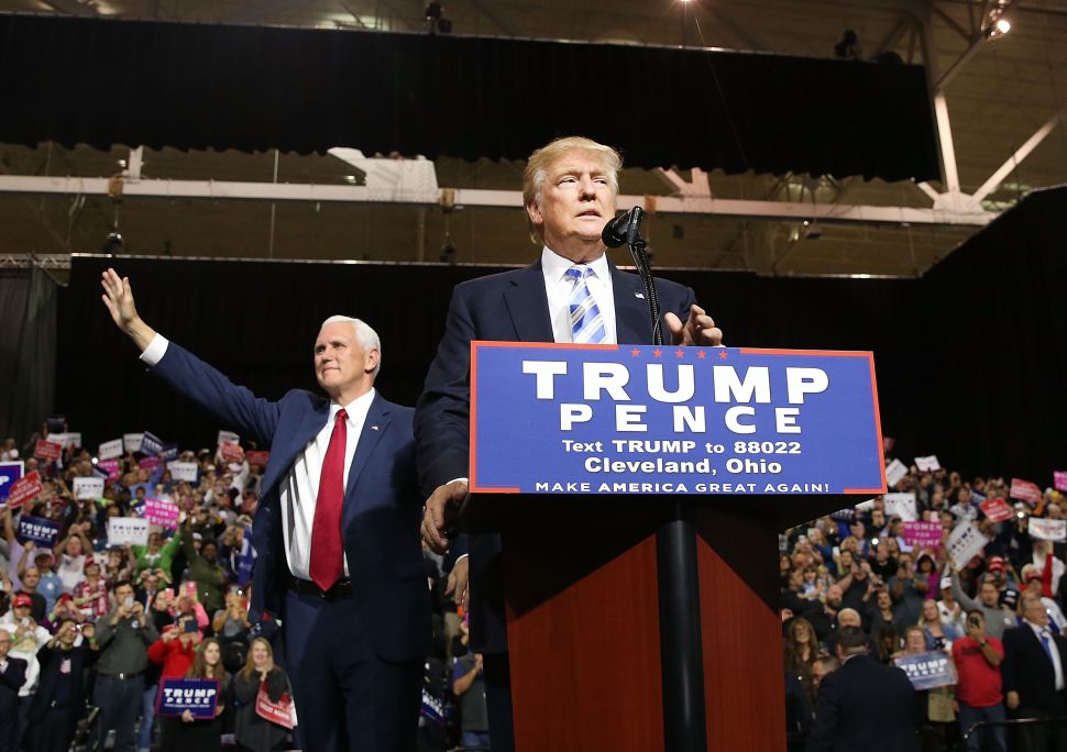 Vice Presidential candidate Mike Pence stands with Donald Trump during a rally on October 22, 2016 in Cleveland, Ohio. 