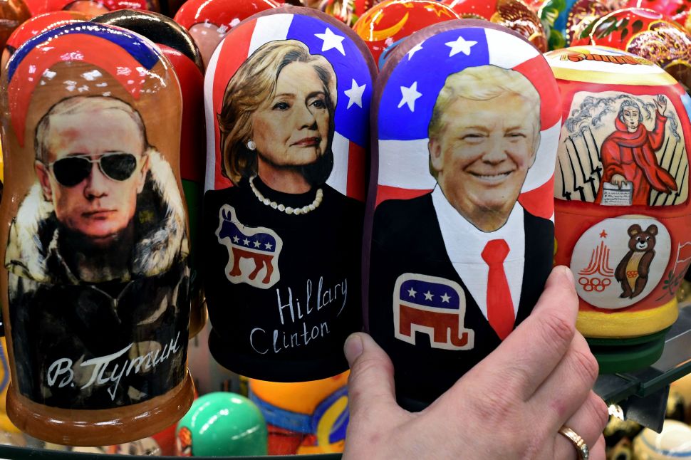 TOPSHOT - Traditional Russian wooden nesting dolls, Matryoshka dolls, depicting Russia's President Vladimir Putin, US Democratic presidential nominee Hillary Clinton and US Republican presidential nominee Donald Trump are seen on sale at a gift shop in central Moscow on November 8, 2016. A nervous world turned its gaze to America's 200 million-strong electorate November 8, 2016 as it chooses whether to send the first female president or a populist property tycoon to the White House. / AFP / Kirill KUDRYAVTSEV