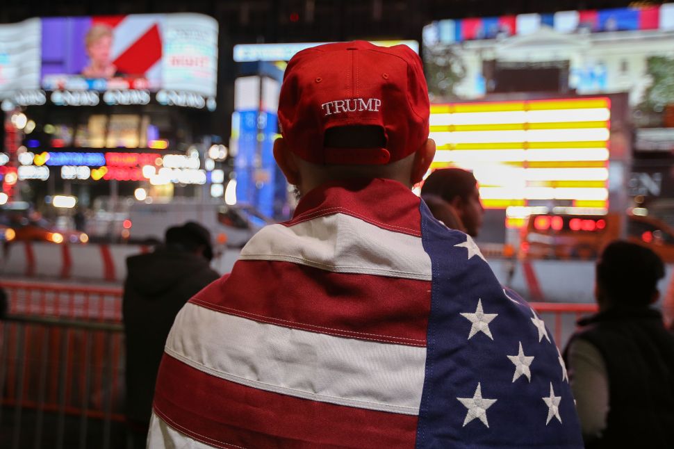 NEW YORK, NY - NOVEMBER 09: A Donald Trump supporter watches the screens outside Times Square Studios as he awaits the results of the U.S. presidental election on November 9, 2016 in New York City. Donald Trump defeated Democratic presidential nominee Hillary Clinton to become the 45th president of the United States.