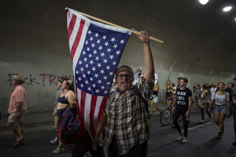 Protesters pass through a tunnel as the march in reaction to the upset election of Republican Donald Trump over Democrat Hillary Clinton in the race for President of the United States on November 12, 2016 in Los Angeles, California, United States. Hundreds of Angelenos have been arrested in recent days and some have vandalized property but the vast majority of the thousands of protesters have remain peaceful.