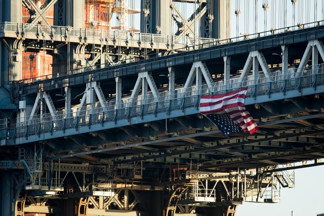 NEW YORK, NY - NOVEMBER 14: Hung by anti-Donald Trump protestors, an upside down American flag hangs from the side of the Manhattan Bridge.