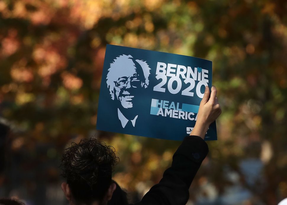 WASHINGTON, DC - NOVEMBER 17: A protester holds up a sign as he listens to Bernie Sanders, (I-VT), speak at a rally, on Capitol Hill, November 17, 2016 in Washington, DC. The National Nurses United, and Progressive Democrats of America held rally to demand "economic and social justice and equality." 