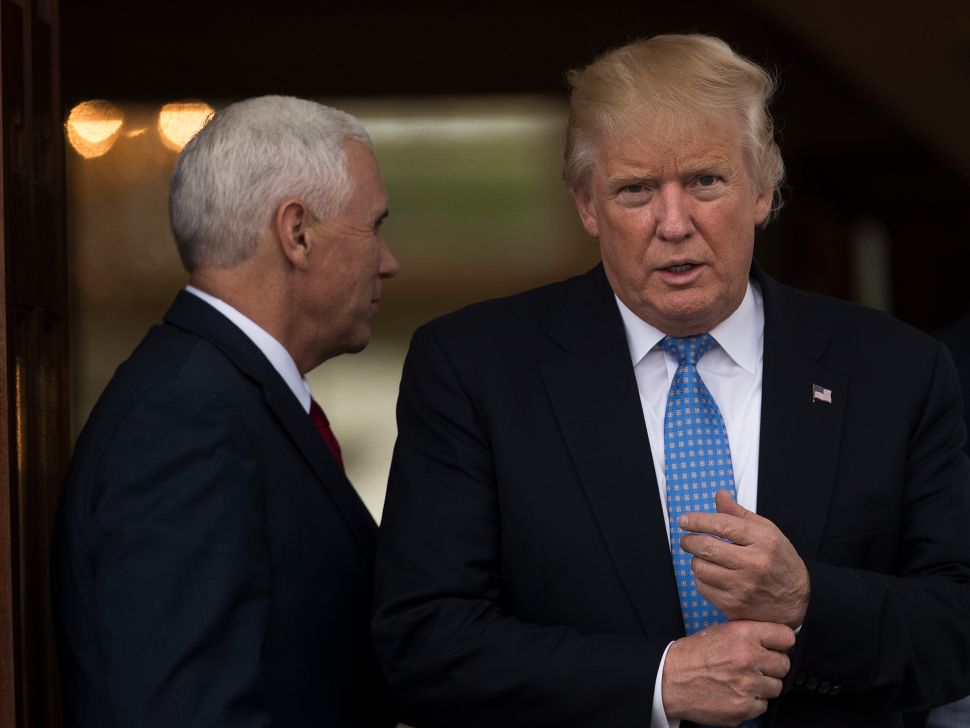 BEDMINSTER TOWNSHIP, NJ - NOVEMBER 20: (L to R) Vice president-elect Mike Pence and president-elect Donald Trump leave the clubhouse following their meeting with Jonathan Gray, member of the Board of Directors at Blackstone, at Trump International Golf Club, November 20, 2016 in Bedminster Township, New Jersey. Trump and his transition team are in the process of filling cabinet and other high level positions for the new administration.
