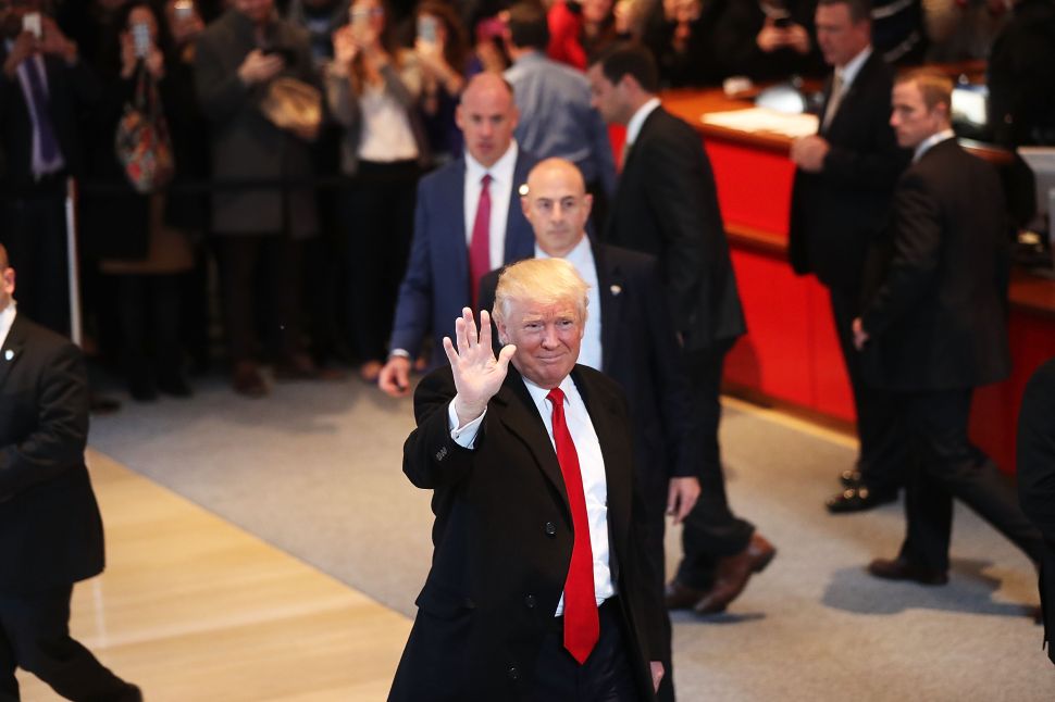 President-elect Donald Trump walks through the lobby of the New York Times following a meeting with editors at the paper on November 22, 2016 in New York City. Trump, who has held meetings with media executives over the last few days, has often had a tense relationship with many mainstream media outlets.