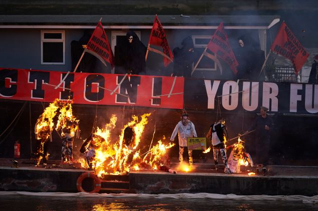 Son of Vivienne Westwood and Sex Pistols creator Malcolm McLaren, Joe Corre, burns his collection of punk memorabilia on a boat moored on the river Thames next to Chelsea Embankment in London on November 26, 2016 in a protest against the Establishments embrace of the 1970s youth movement marking the 40th years since the Sex Pistols released Anarchy in the UK. Corre, son of Sex Pistols manager Malcolm McLaren and the founder of lingerie firm Agent Provocateur, torched the items in protest alongside banners referring to climate change.