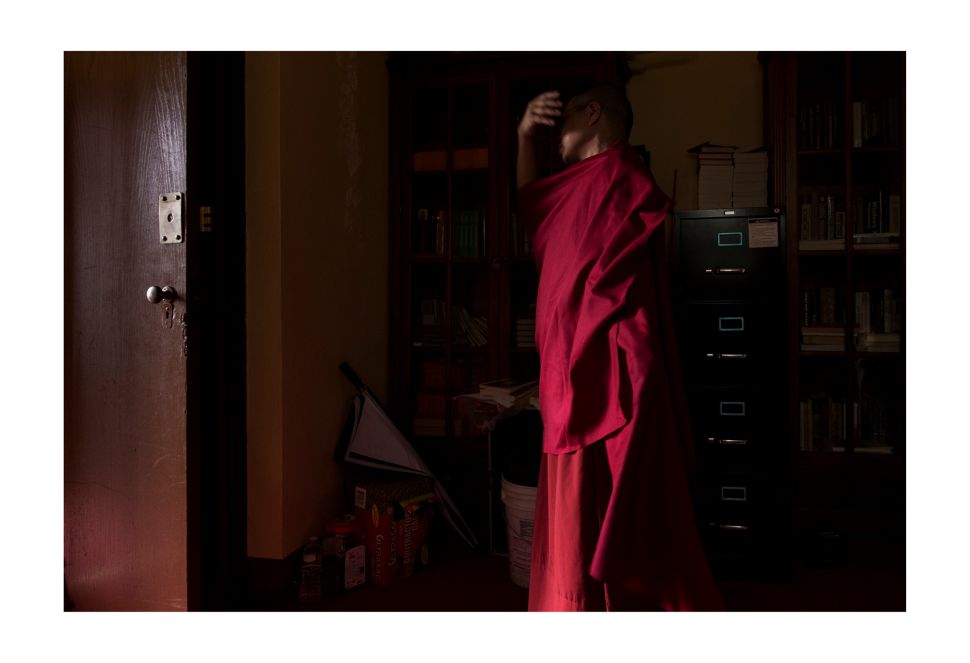 Ang Pasang, a monk, prepares to make his prayers.