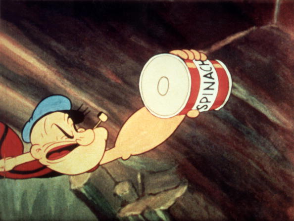 Popeye reaches for a can of spinach in a still from an unidenitified Popeye film, c. 1945.
