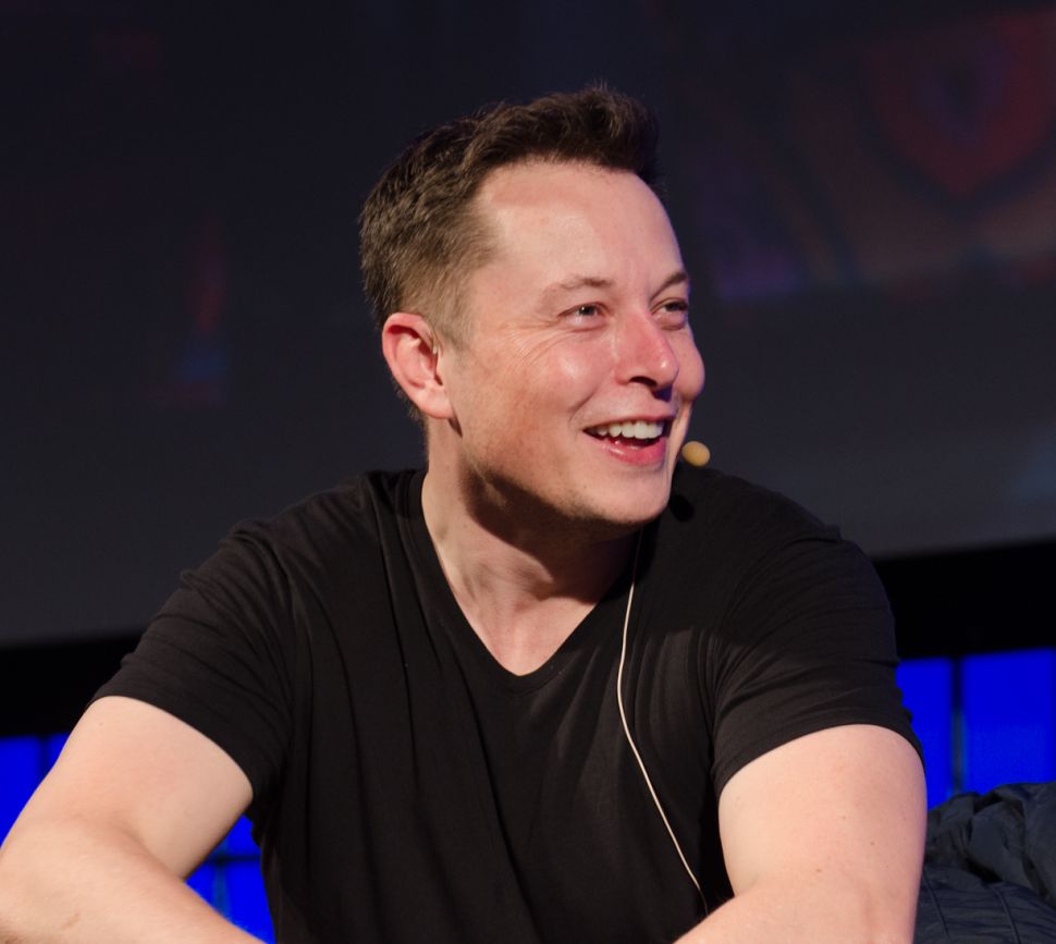Elon Musk smiling at all the puns in his Twitter mentions.